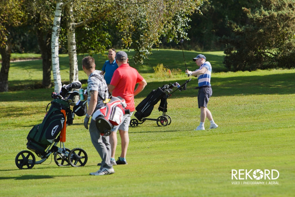 Teams in action during golf day