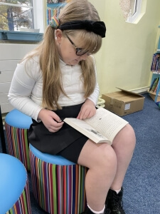 Tavistock Primary School pupil reading a new book