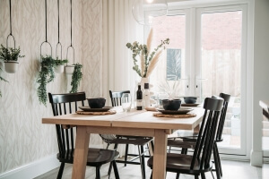 Up-close photograph of a laid kitchen table with chairs around it
