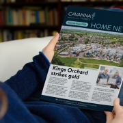 picture of person reading Home News magazine