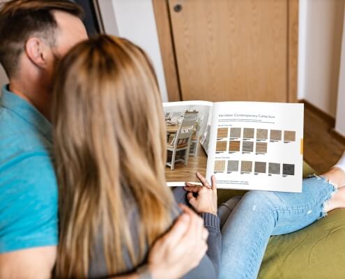 Home buyers reading the finishing touches brochure