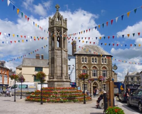 Launceston war memorial in the town centre, with bunting hanging from it