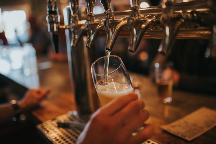 Man pouring a beer in a pub